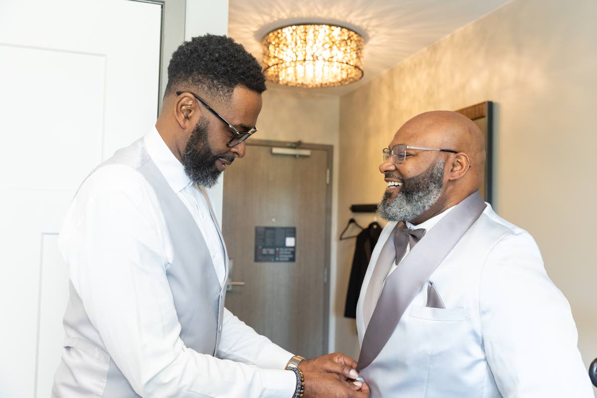 The groom, Michael Grant (right), gets full attention from his best man and uncle, Dwayne Grey.
