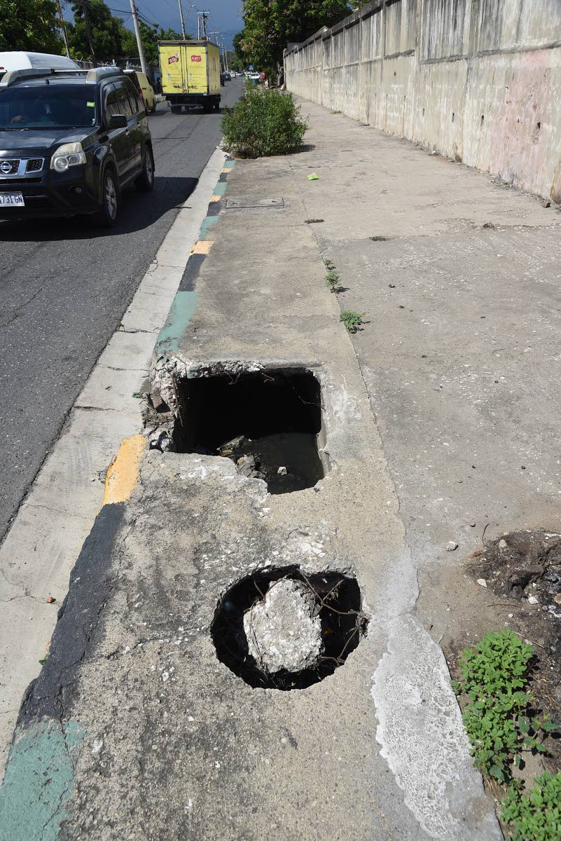 Holes in another section of the sidewalk along Slipe Pen Road.