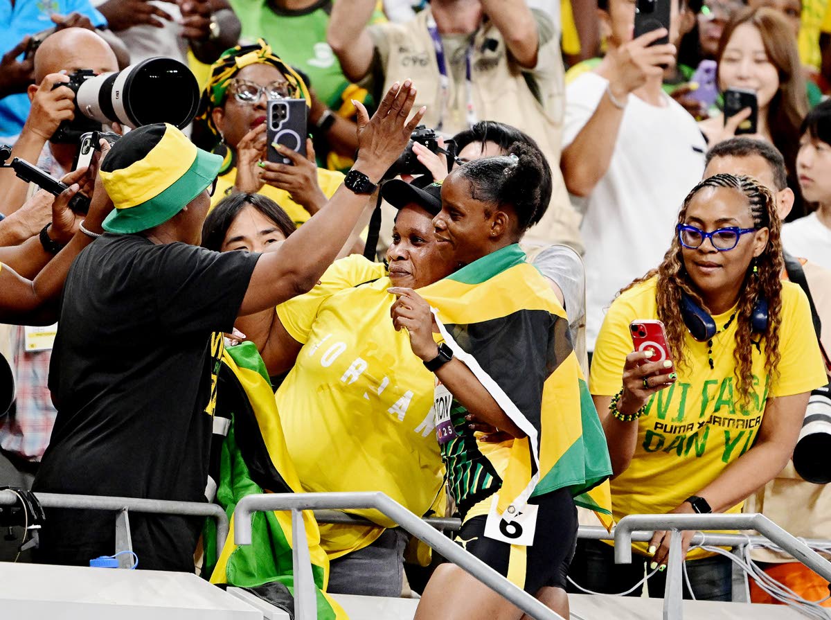 Tina Clayton (right, foreground) celebrates with her mom Tishawna Pinnock in the stands after winning the silver medal in the women’s 100 metre final on day two of the World Athletics Championships in Tokyo yesterday.