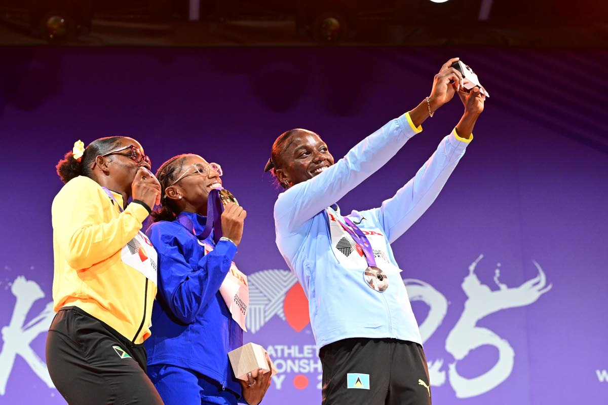 World Athletics Championships 100-metre bronze medallist St Lucia’s Julien Alfred (right) takes a selfie with silver medallist, Jamaica’s Tina Clayton, and world champion Melissa Jefferson-Wooden during a ceremony in Tokyo, Japan.