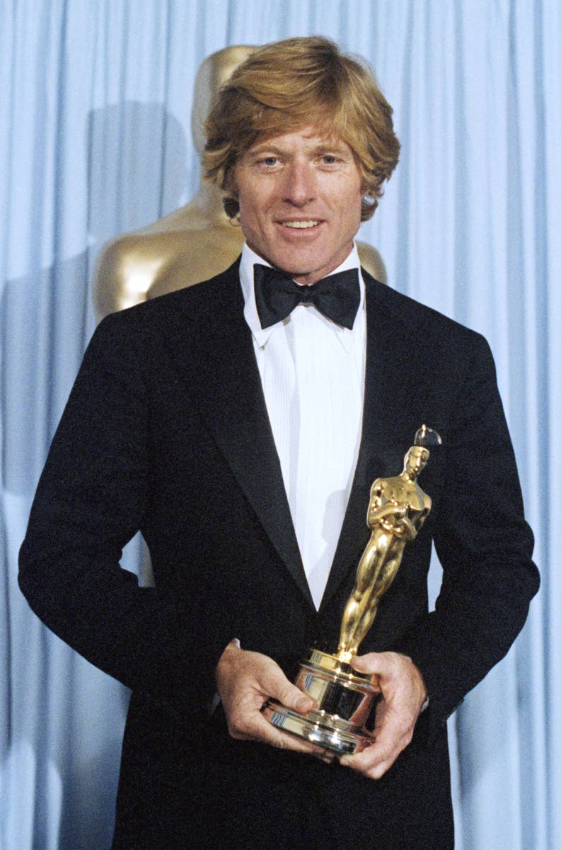 Robert Redford holds the Oscar he won for best director ‘Ordinary People’ at the Academy Awards in Los Angeles on March 31, 1981. 