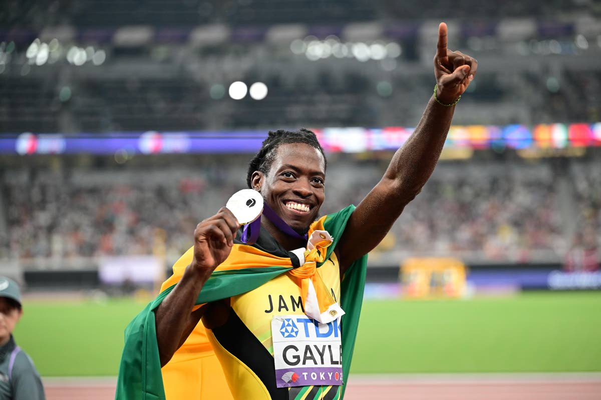 Tajay Gayle shows off the silver medal he mined from the World Athletics Championships long jump yesterday with his leap of 8.34 metres.  
