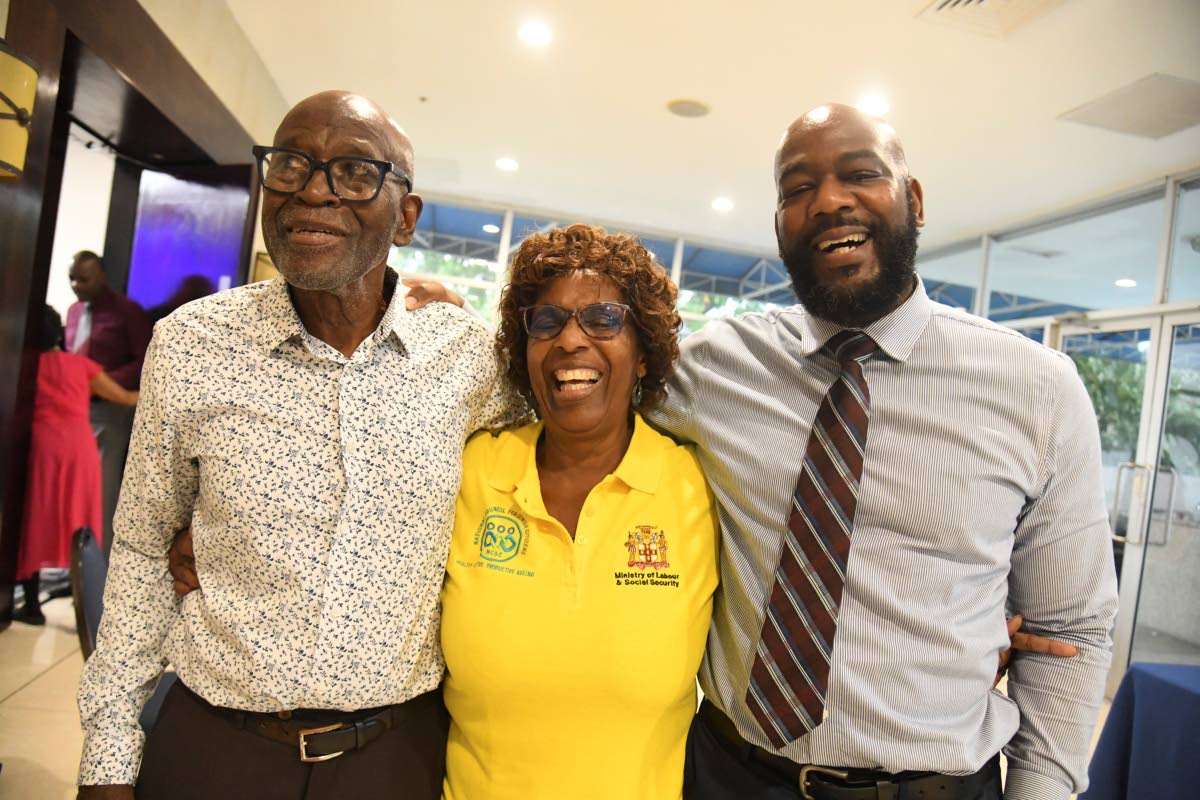 Celebrating her well-deserved win, Beverly Been is flanked by her husband Basil Been (left) and her son Andre Vaccianna.