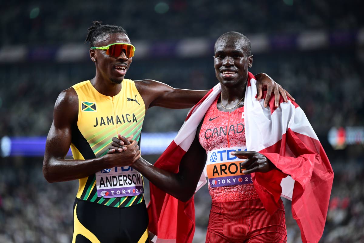 Jamaica’s Navasky Anderson (left) congratulates former training partner, Canada’s Marco Arop, for the bronze medal he won in the men’s 800 metres. 