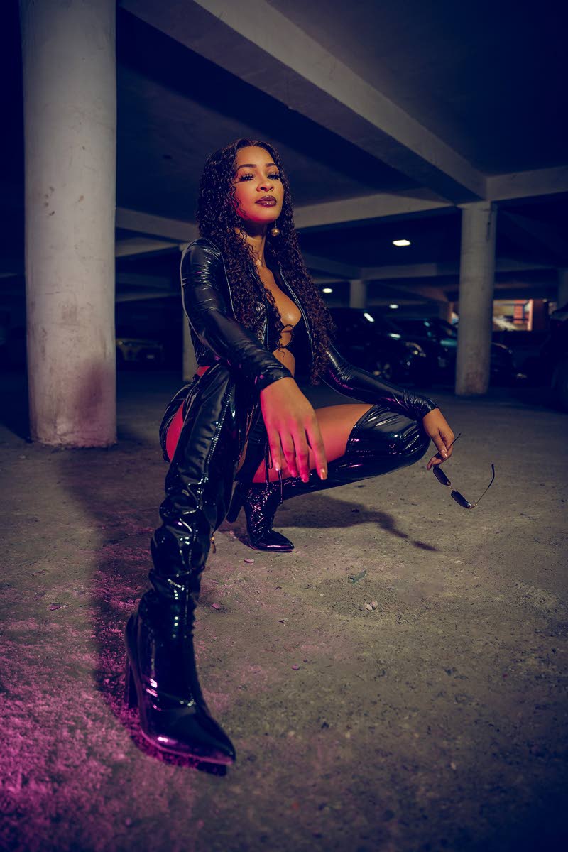 AnnaleaX taps into her sensual side with these thigh-high leather boots and an all-black outfit to match. 