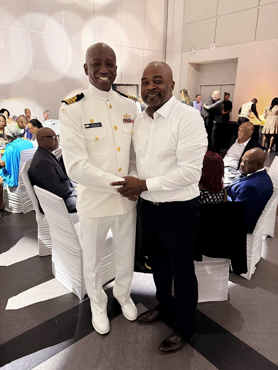Commander Paul Smith (left), Royal Canadian Navy, and Chris Campbell who was honoured at a retirement brunch on September 21.