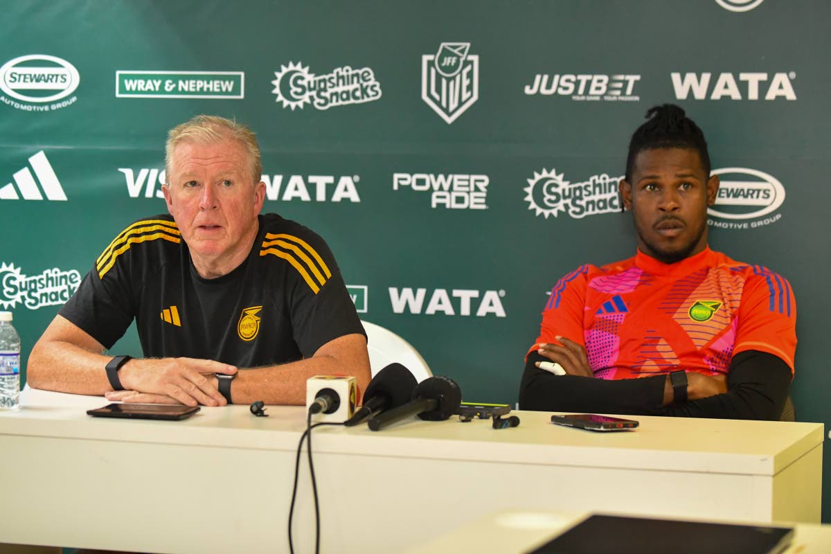 Reggae Boyz head coach Steve McClaren (left) and team captain Andre Blake speak during a Jamaica Football Federation press conference at the National Stadium yesterday.