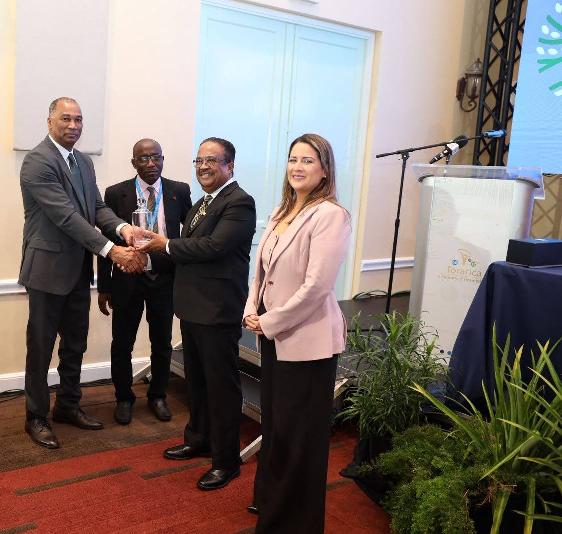 William Brown (left), president of the Caribbean Shipping Association (CSA), presents a token of appreciation to Gregory Rusland (second from right), vice-president of Suriname, during the 55th AGM, Conference and Exhibition of the CSA in Paramaribo. Shari