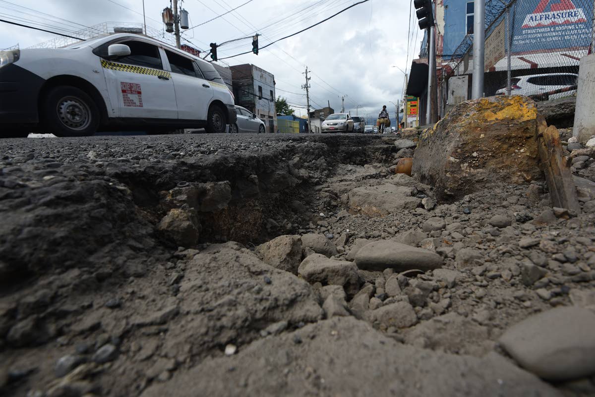 A huge pothole at the junction of Slipe Road and Studio One Boulevard in Kingston. Motorists complain that the pothole has been there for more than six months and has got wider as a result of recent rains. 