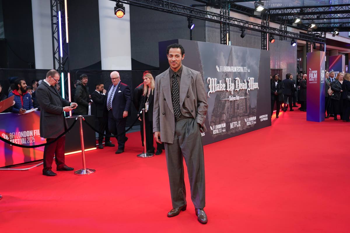 Daryl McCormack styles his Emporio Armani grey double-breasted suit with a polka dot tie. 