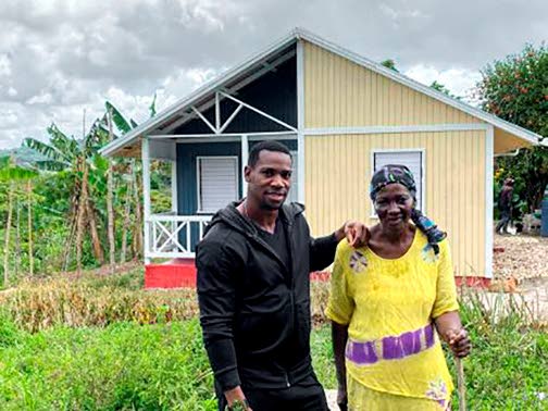 
Jamaican sprinter Yohan Blake (left) with Irene Morgan standing before her new house that Blake financed the construction of as Mother’s Day gift for her 1n 2022.