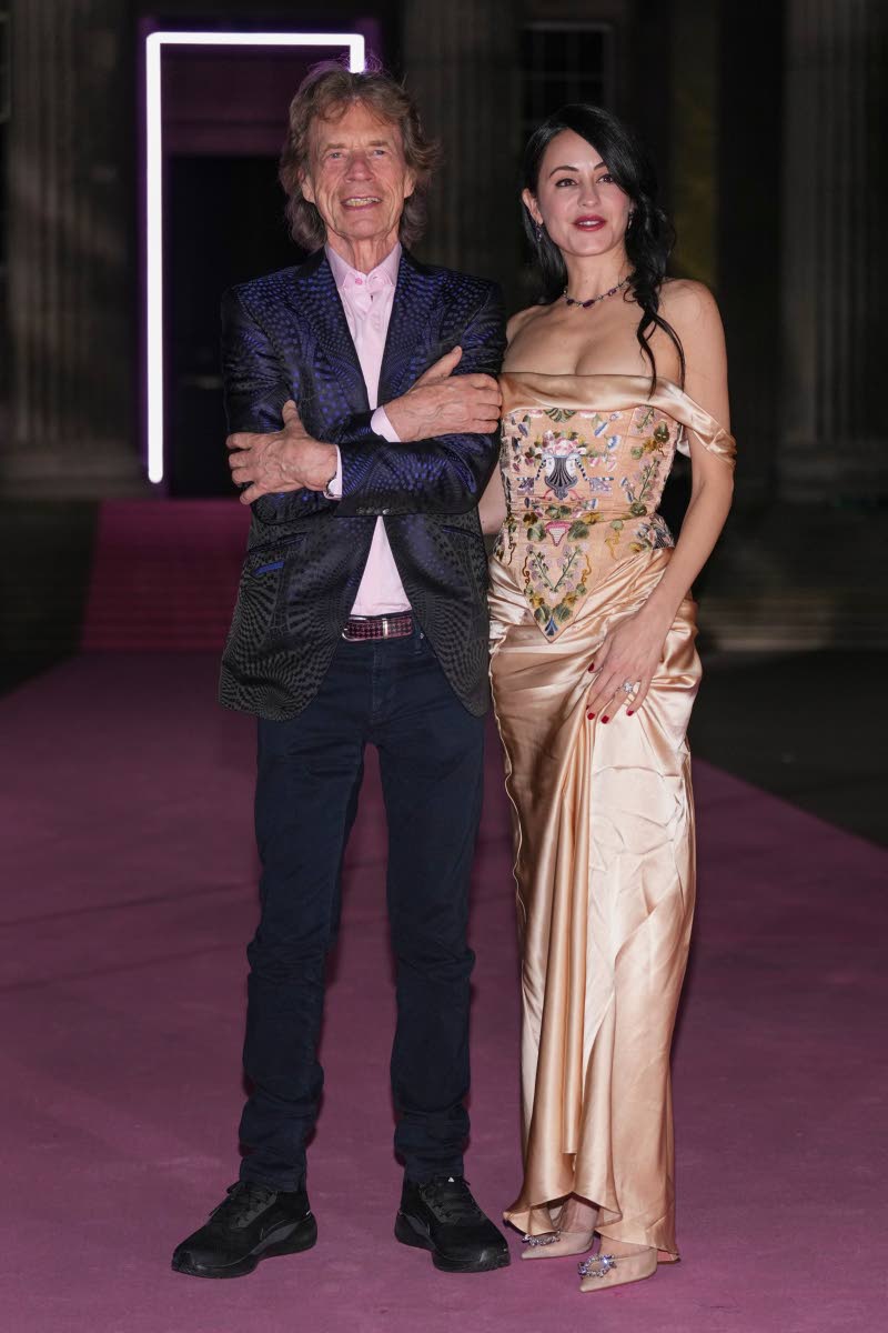 Mick Jagger (left) and Melanie Hamrick pose on the pink carpet, Hamrick in Annie’s Ibiza.