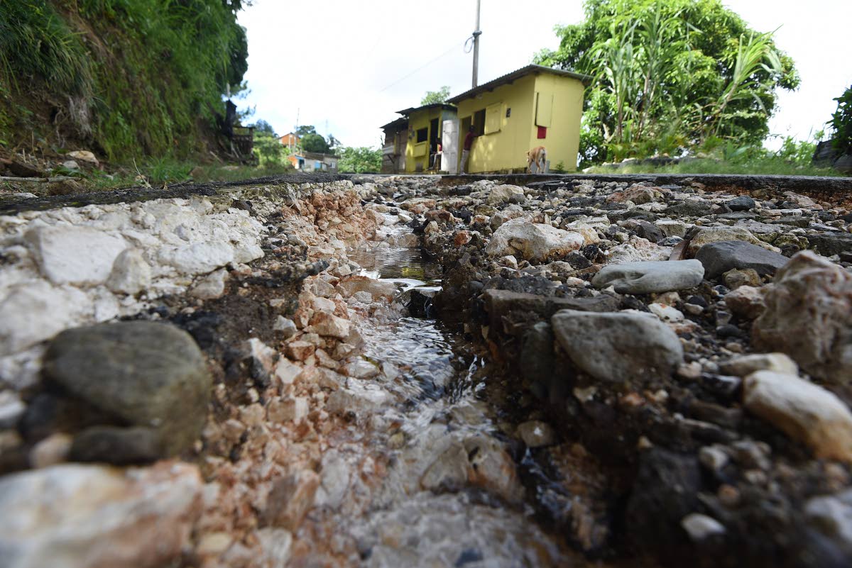 A section of the deteriorating Mount Airy roadway in St Andrew West Rural. Residents like shopkeeper Donna Ferguson fear this weekends weather events could make the road conditions worse.