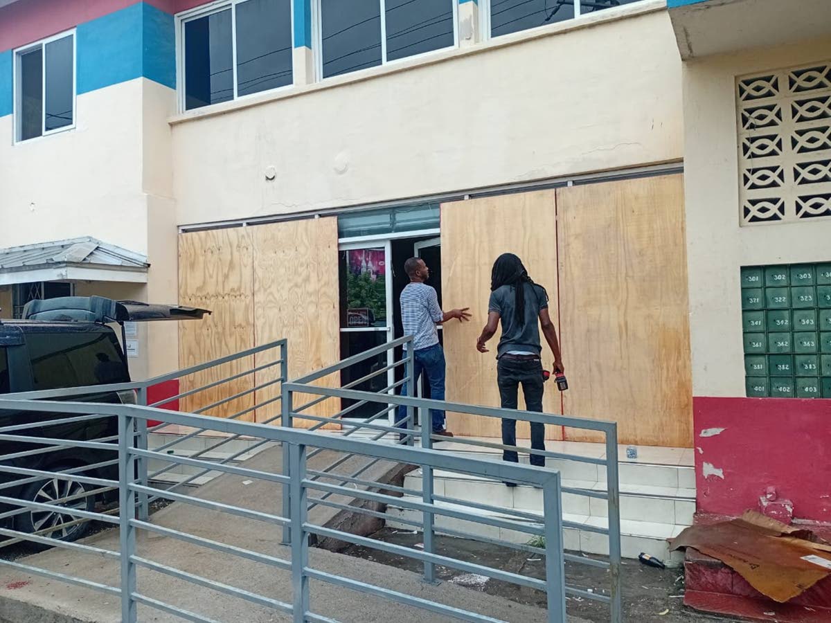 Workmen securing the Ocho Rios Post Office on Friday, October 24, ahead of the passage of Tropical Storm Melissa.