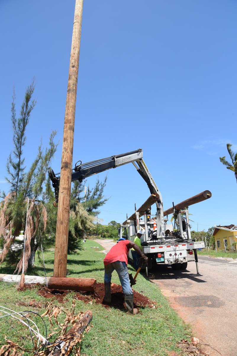 July 2024 file photo: A Jamaica Public Service crew replants a utility pole along the Southfield to Flagaman main road in St Elizabeth that got broken in two during the passage of Hurricane Beryl.