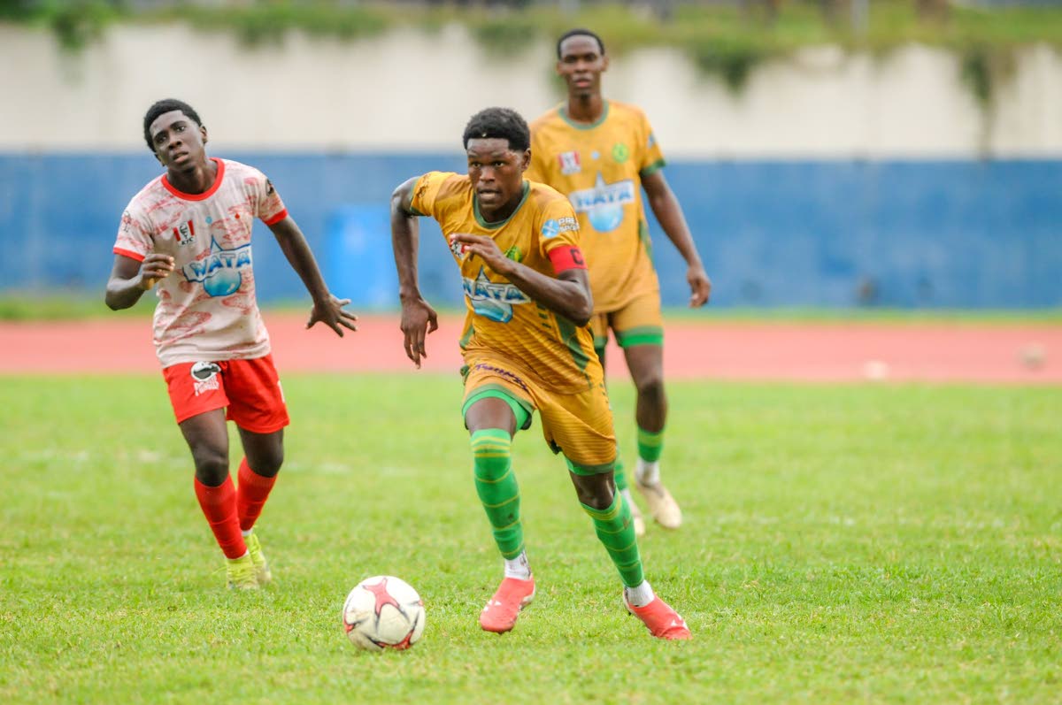 St Jago High School’s Jordan Taylor (right) dribbles away from Mona High School’s Franklyn Mitcham during their ISSA/WATA Manning Cup encounter at the Jamaica College Ashenheim Stadium on October 22.