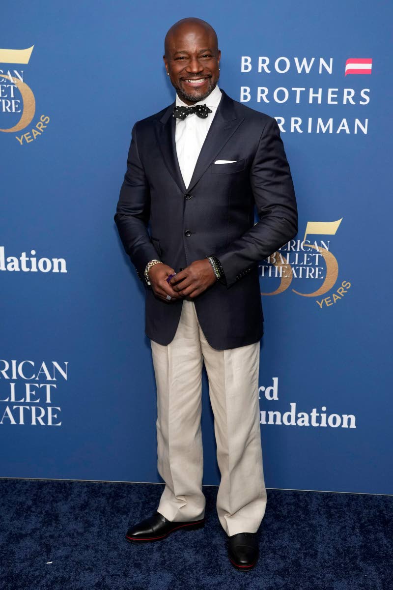 Taye Diggs shows off his preppy style with a navy blazer, tan trousers and polka dot bow tie. 