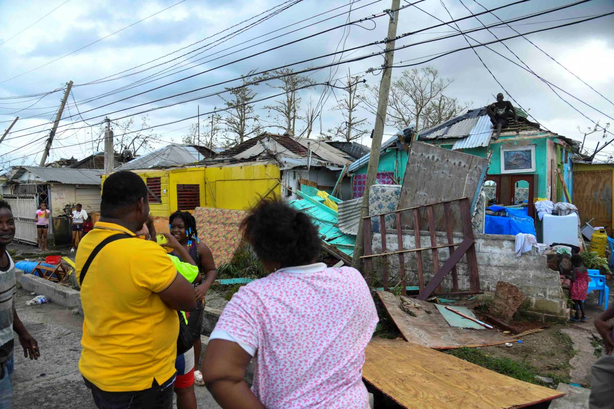 Residents of Cornwall Street, Compound in Trelawny look at the damage done to their homes after the passage of Hurricane Melissa, which swept through the island on October 28.