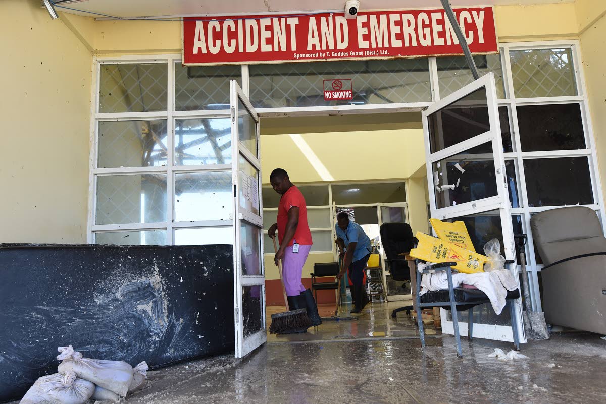 Workers clean the entrance to the Accident and Emergency to the Falmouth Hospital in Trelawny after it was exensively damaged during the passage of Hurricane Melissa.
