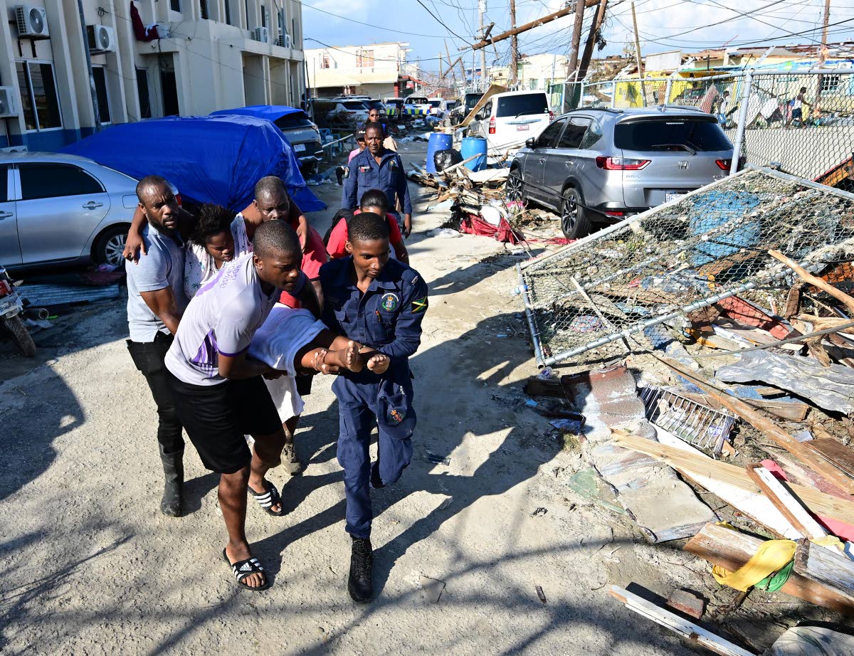 
A woman being taken to the Black River Police Station for medical attention after collapsing in the street last week.