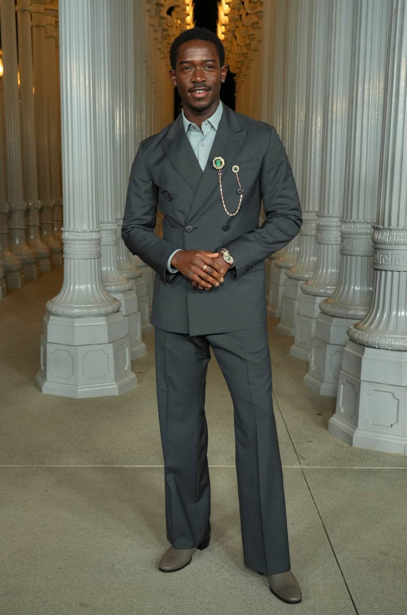 Damson Idris serves style in a double-breasted grey Prada suit. 