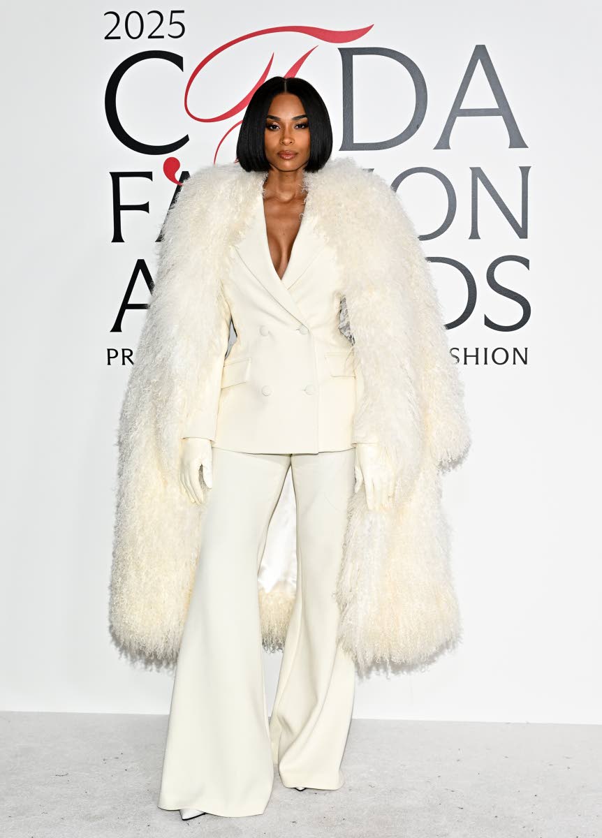 Above: Ciara commands attention in a white Sergio Hudson power suit, pairing a double-breasted blazer with wide-leg trousers and carrying a voluminous ivory fur coat for extra drama.