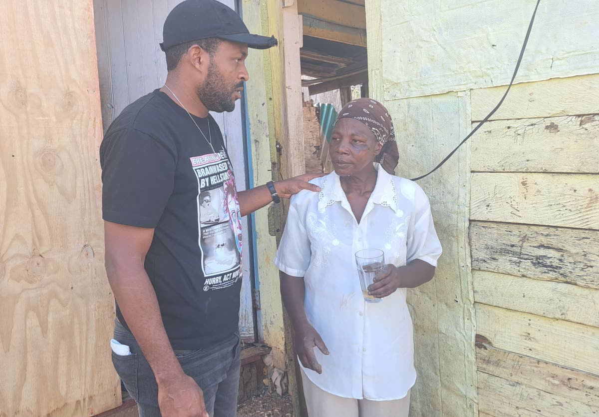 Carl Grant, councillor for the Lluidas Vale Division in St Catherine, seeks to reassure resident Sharon Small, whose one-bedroom house was blown away by Melissa’s outer bands.