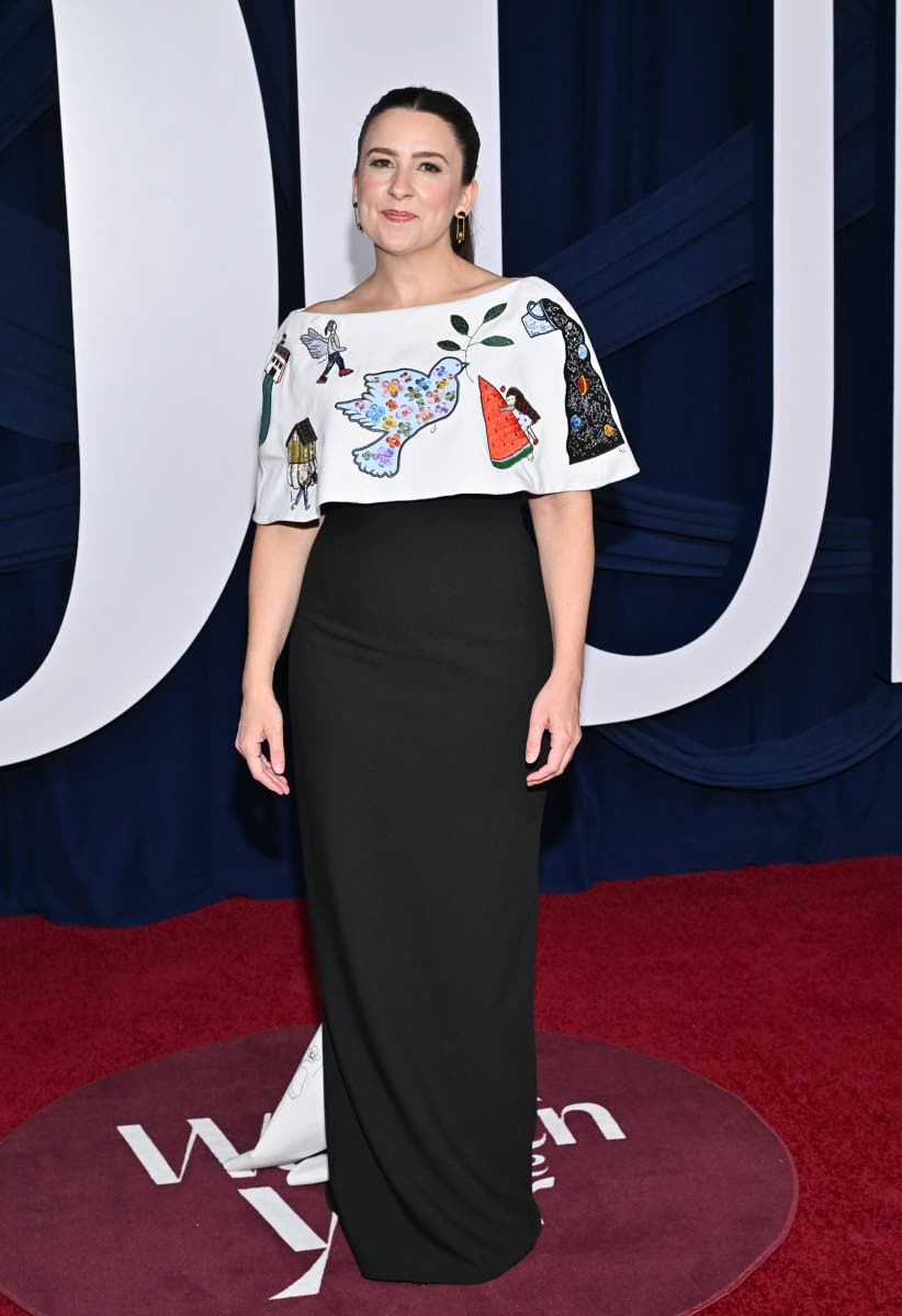 A 2025 Woman of the Year, Rachel Griffin Accurso, more popularly known as Ms Rachel, wears a custom upcycled dress embroidered with artwork from children in Gaza.