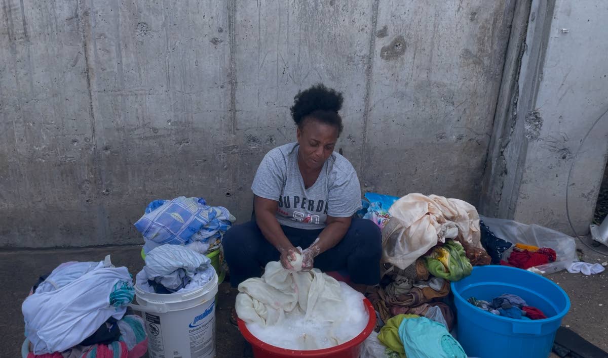Rose Heights resident Cherry doing her laundry in the proximity of the Sangster International Airport in Montego Bay, St James.