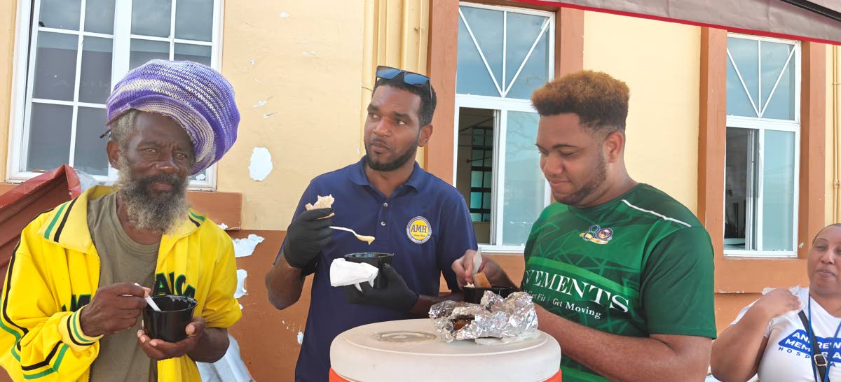 Karl McDonald (left), a patient at the Black River Hospital, enjoys his porridge with AMH workers Dalmain Black (centre) and Chad Artwell during AMH’s outreach at the hospital on Tuesday.