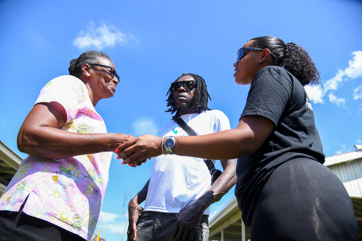 From left: Vivienne Williams, supervisor at Westhaven Children’s Home; dancehall star Vybz Kartel and Daniella Hall, community outreach organiser for Central Jamaica at World Central Kitchen on the grounds of Westhaven Children’s Home in Hanover on Thu