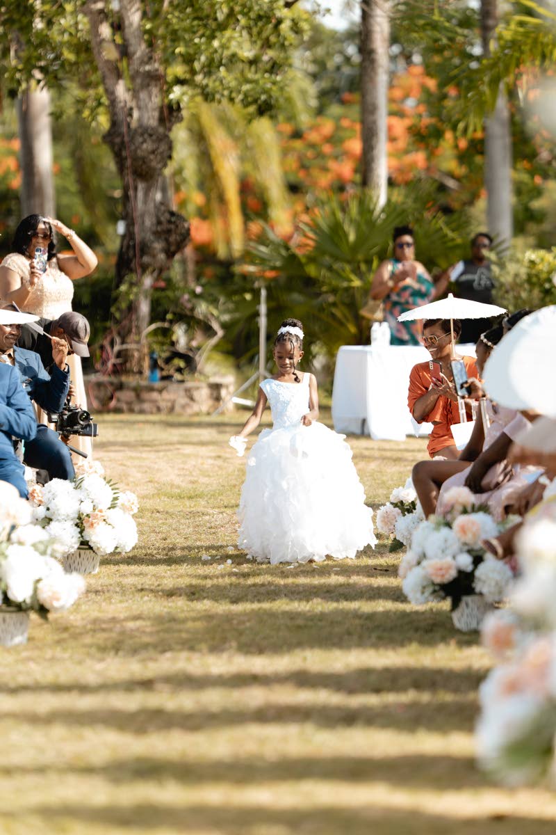 The cutest flower girl, Roshae Edwards, walked up the aisle, scattering petals ahead of her cousin, Kamille.