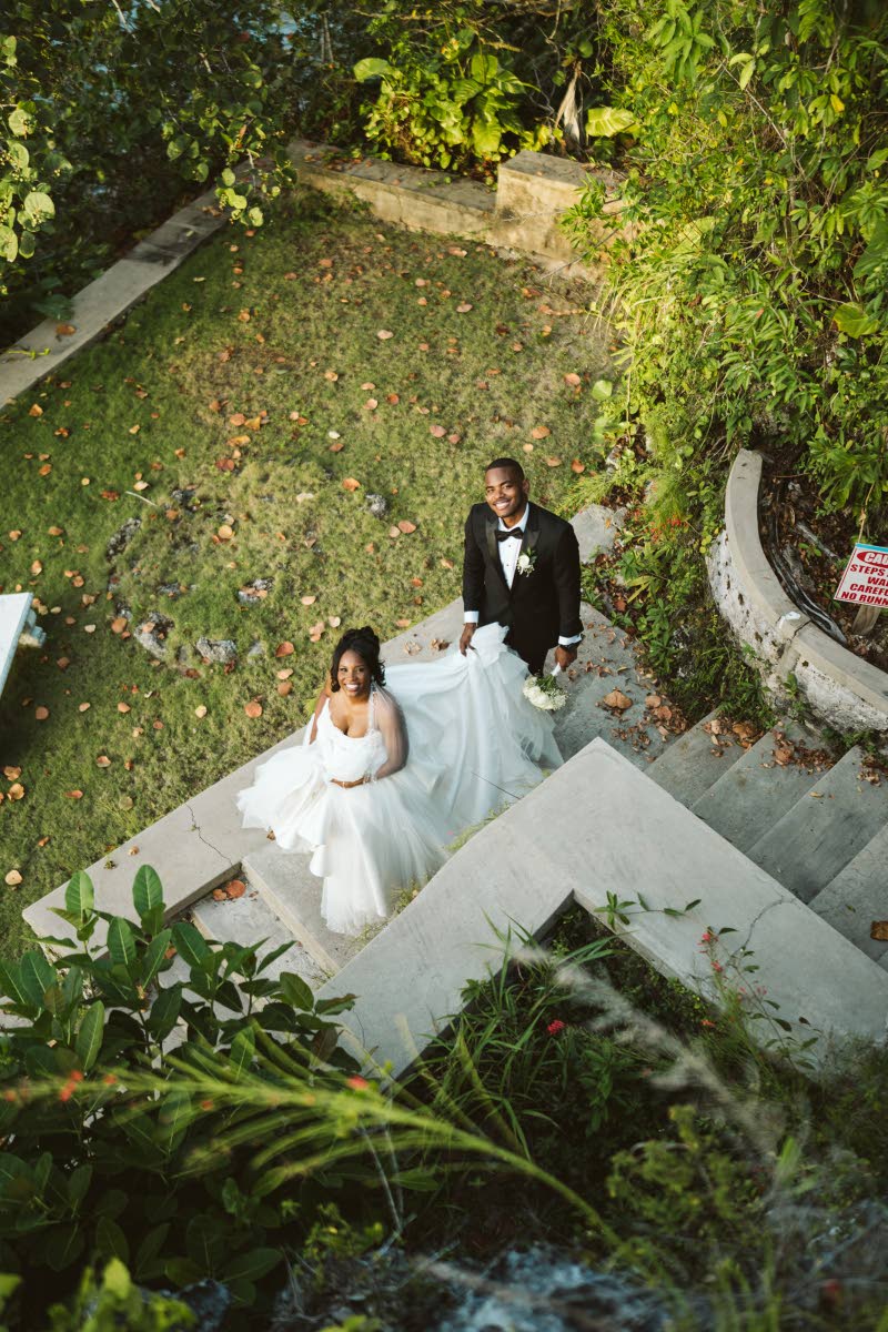 Just married and glowing, Kamille and Richard share a quiet moment between the cheers.