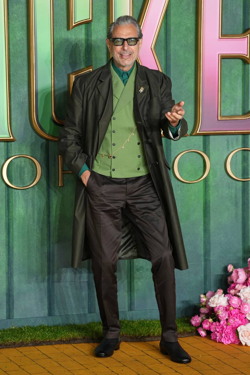 Jeff Goldblum, the Wizard of Oz in ‘Wicked’ sequel, turns heads in a brown Prada coat layered over a green vest and brown chinos, finished with sleek black shoes.