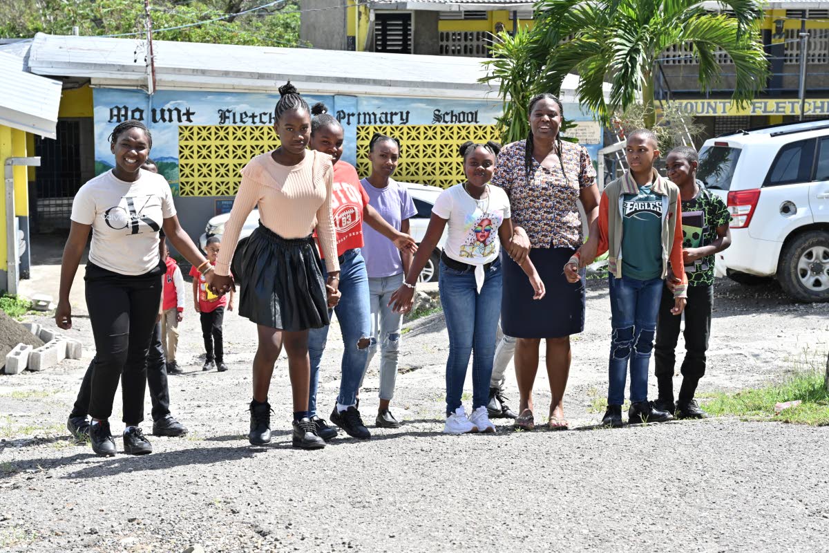 Nicola McCarthy (third right), grade-six teacher, with her students back in school at the Mount Fletcher Primary in Mavis Bank, St Andrew, after Hurricane Melissa.