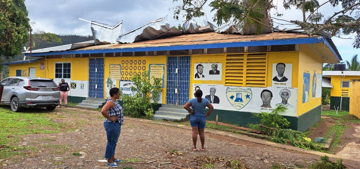 Teachers survey roof damage at Baxter’s Mountain Primary in St Mary.