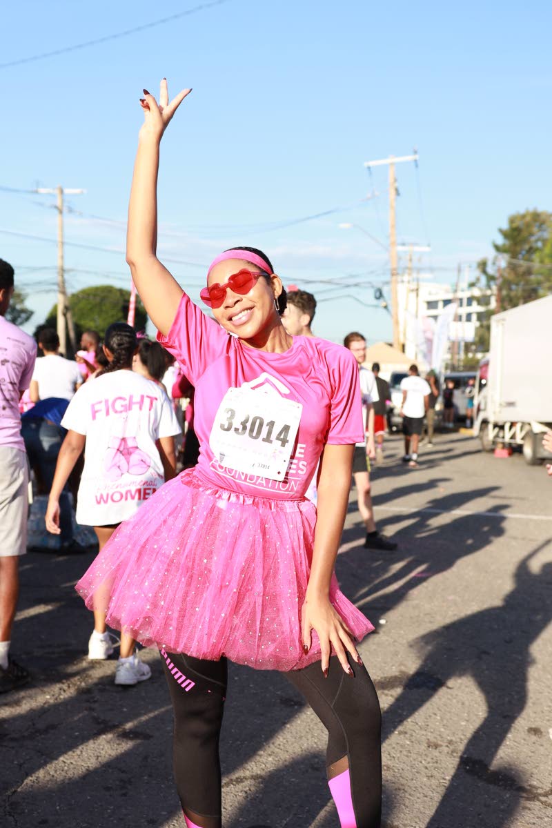 Joamie Tweed strikes a playful pose after crossing the finish line.