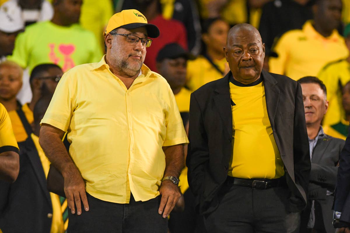 Opposition Leader Mark Golding (left) and Jamaica Football Federation President Michael Ricketts showed every bit of emotion on their faces.