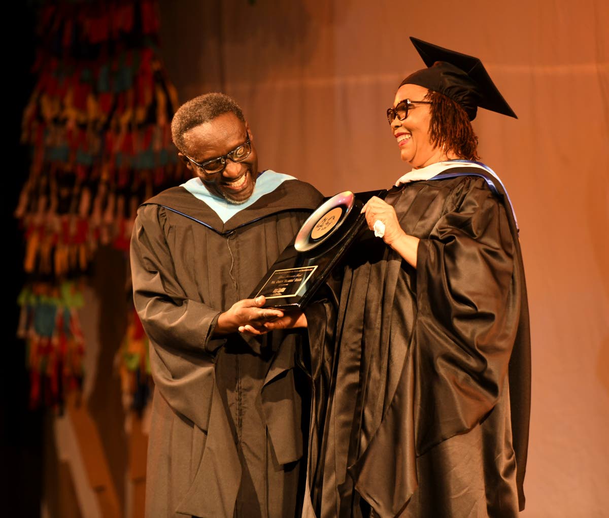 Comedian and educator Owen ‘Blakka’ Ellis soaks in the moment during his Lifetime Achievement award presentation at the Edna Manley College graduation, while Dorrett Campbell, principal, looks on.
