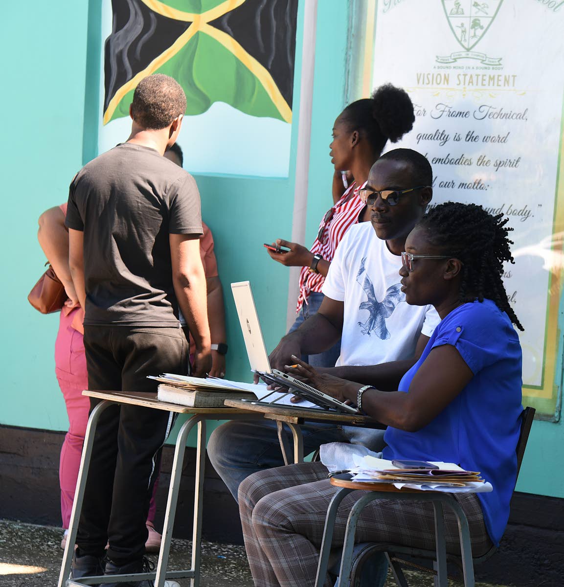 Telisha Jordine-Harvey (right) and Tiska Brown (second right), Caribbean Secondary Education Certificate exam coordinator at Frome Technical High, conducting registration exercises at the school on Wednesday.
