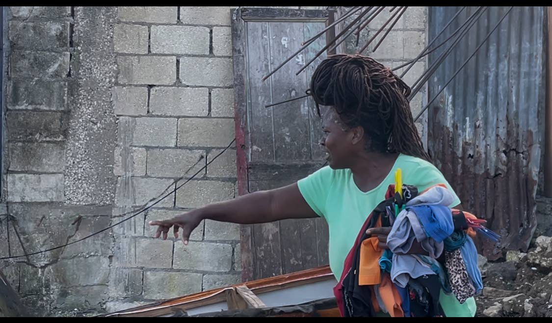 Beverley Watson Barker pointing to where a part of her house once stood.