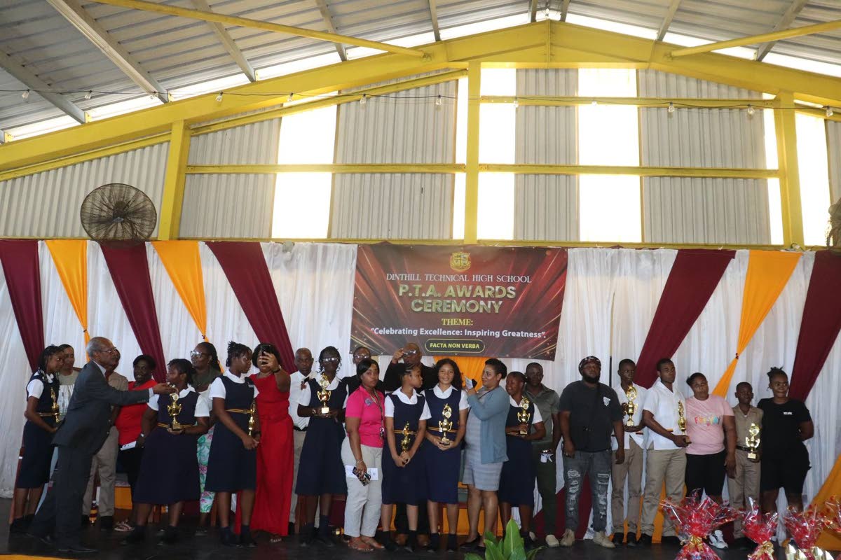 Awardees, parents, guardians and members of the Parent-Teachers’ Association pose with their awards during Dinthill High School’s ceremony at the Enos Barrett Multi-Purpose Hall.