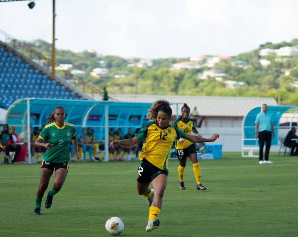 Left: Reggae Girlz’ Kalyssa Vanzantien gets ready to kick the ball during a Concacaf W qualification game against Dominica at the Daren Sammy Cricket Ground in St Lucia yesterday.