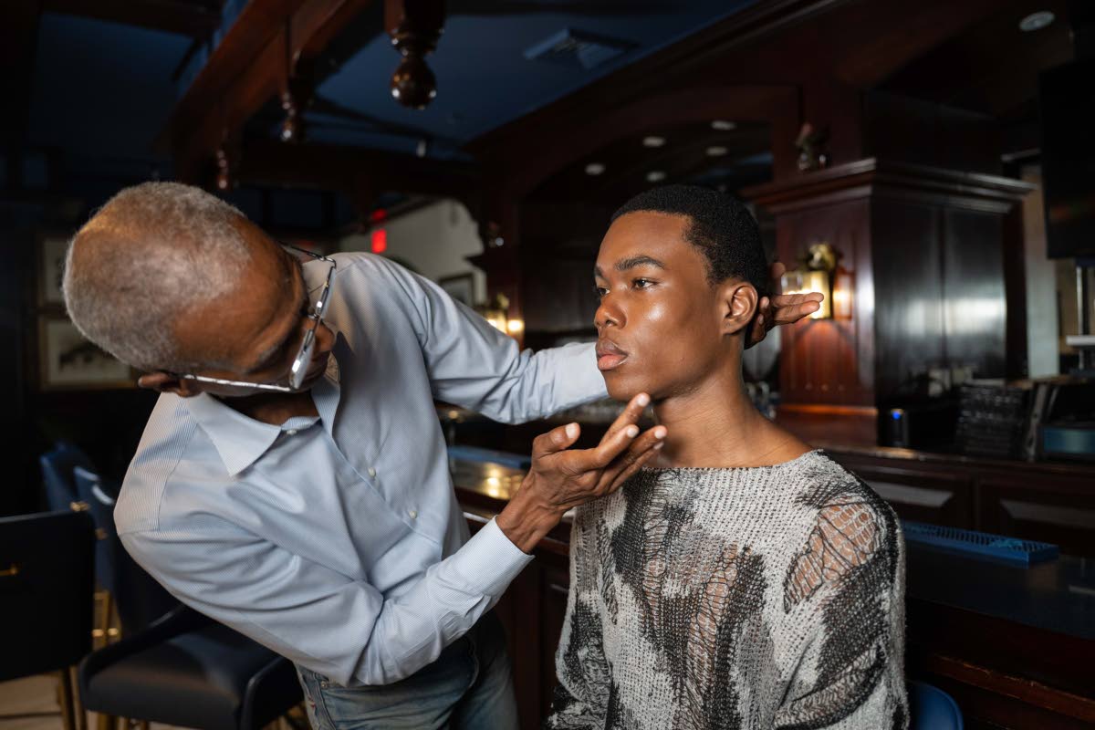 Melbourne (left), who has worked for Versace and Dolce and Gabbana on advertising campaigns, puts his expertise on show with a make-up demonstration on SAINT model Jahiel Thompson.