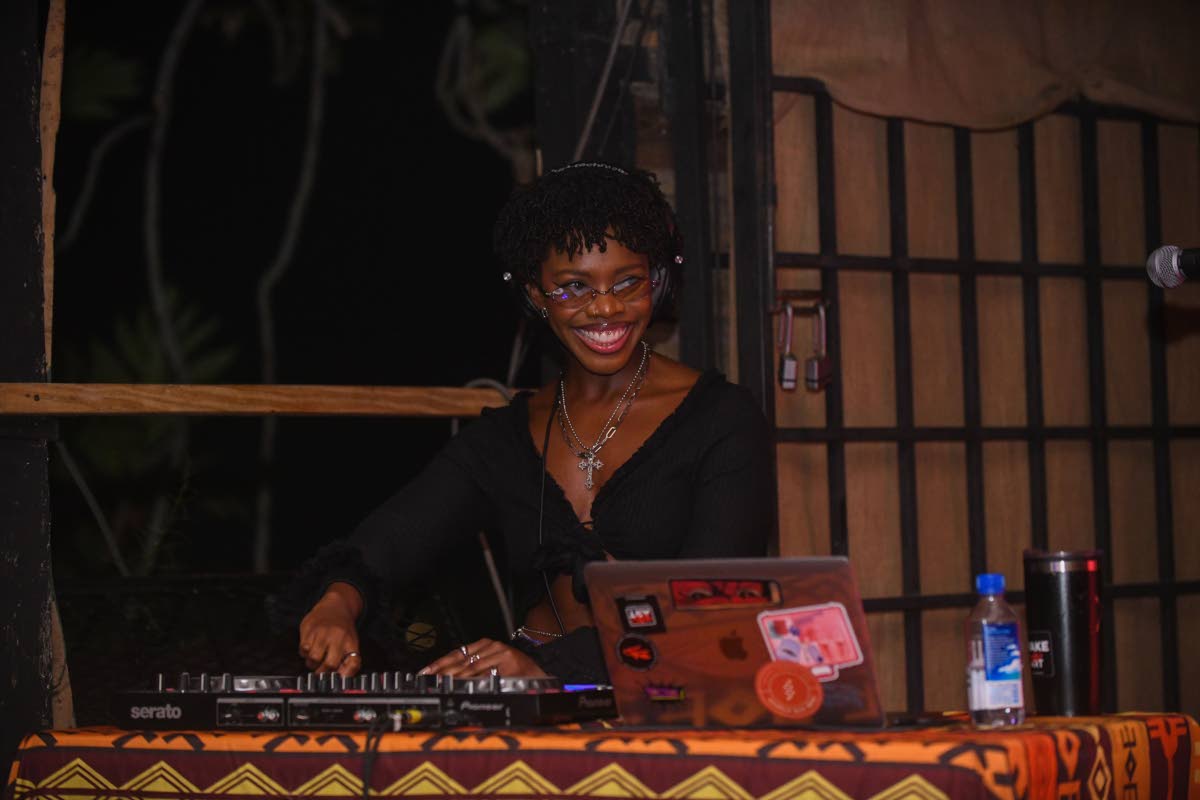 DJ Reiizzzr is sharp on the ones and twos as she flashes a smile for the audience.