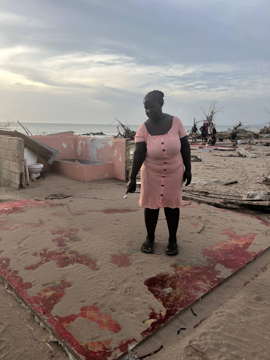 Sheron Watson standing on what was once her living room in Parottee, St Elizabeth.