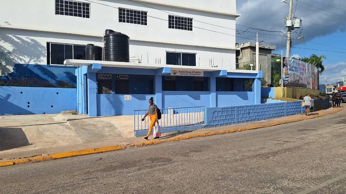 A woman walks past the Junction Public Sanitary Convenience that remains closed to the public after it was opened by Local Government Minister Desmond McKenzie in August. 