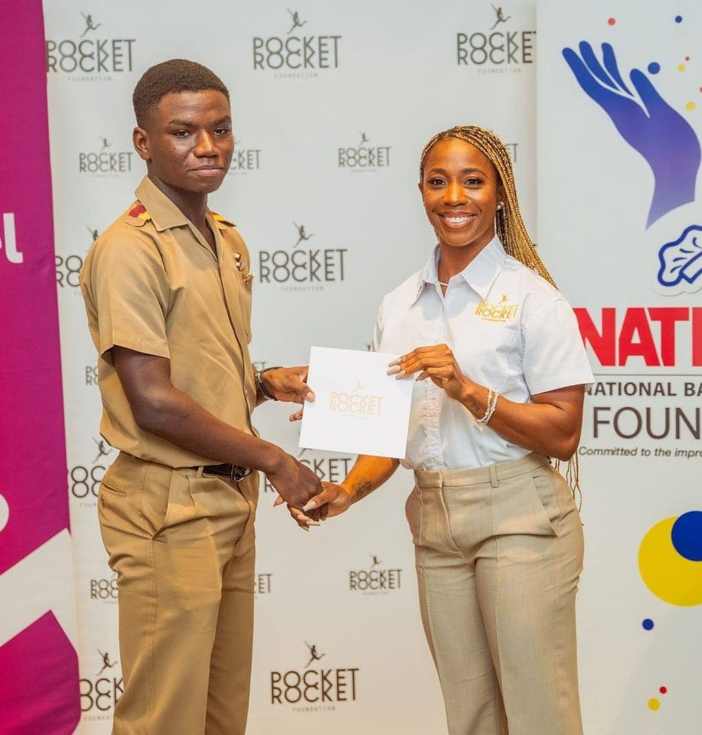 Contributed Photos
Looking back to where it all started. Wolmer’s Boys’ School’s Joel Lamm (left) receives a scholarship from Shelly-Ann Fraser-Pryce on behalf of the Pocket Rocket Foundation, giving rise to his aspirations to excel in both academics