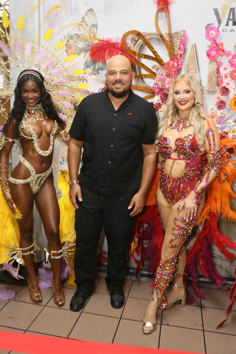 Andrew Bellamy, managing director of Yard Mas Carnival, is flanked by Rachel Silvera (left), Miss Universe Jamaica 2024, wearing Dali, and Canadian model Nicole Arbour, wearing Ebony.