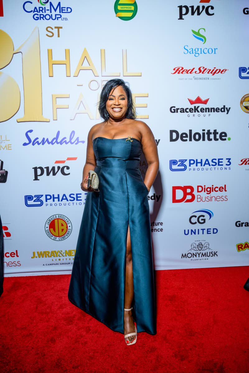 Karen Hall, assistant vice president of sales at Mayberry Investments, dons a navy teal dress accented with a statement brooch.